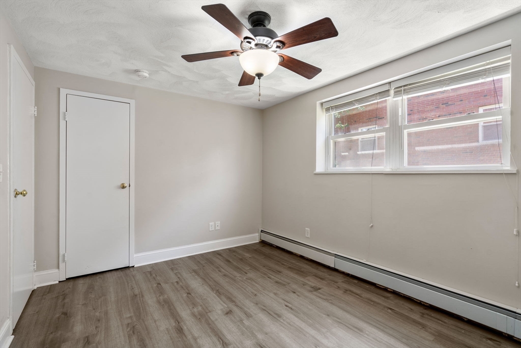 1105 Lexington Street, Unit 41 Waltham, MA 02452 - Photo 8 of 19 wooden floor in an empty room with a window
