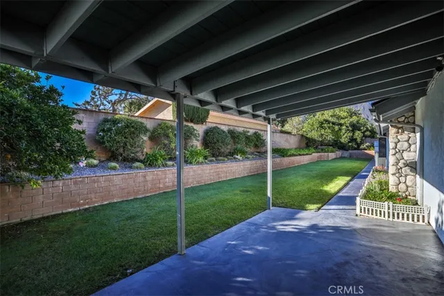 a view of yard with swimming pool and green space