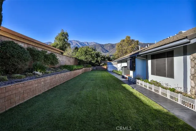a view of empty room with window and chandelier