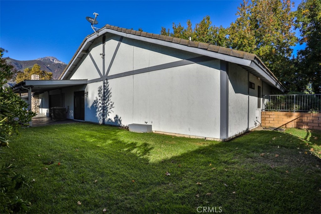 5848 Burlwood Court Rancho Cucamonga, CA 91701 - Photo 17 of 71 a backyard of a house with plants and large tree