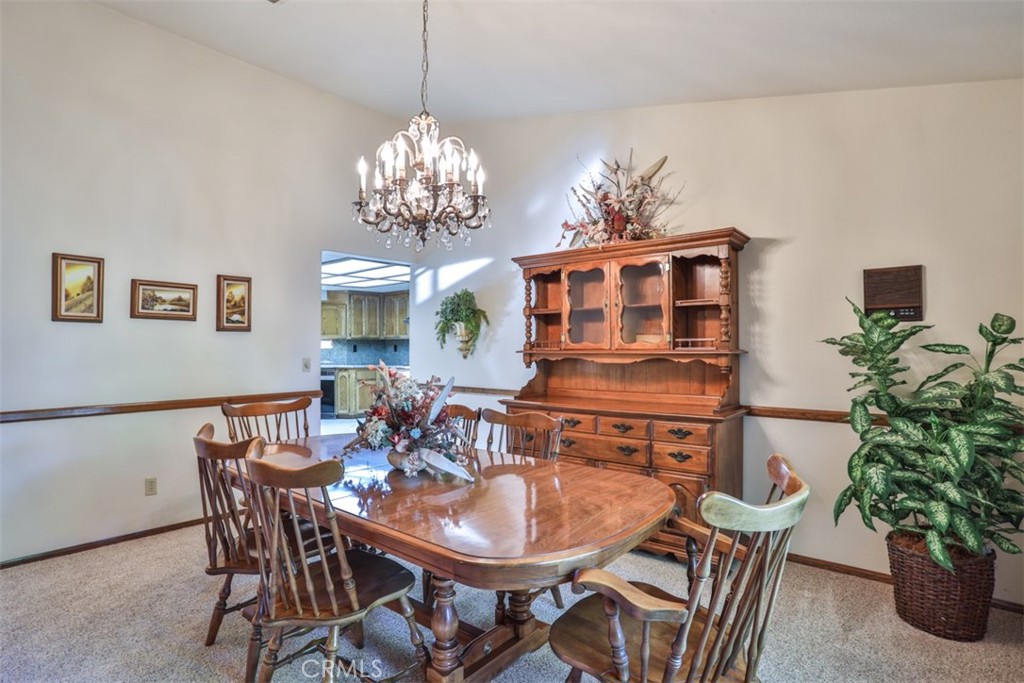 5848 Burlwood Court Rancho Cucamonga, CA 91701 - Photo 33 of 71 a view of a dining room with furniture and chandelier