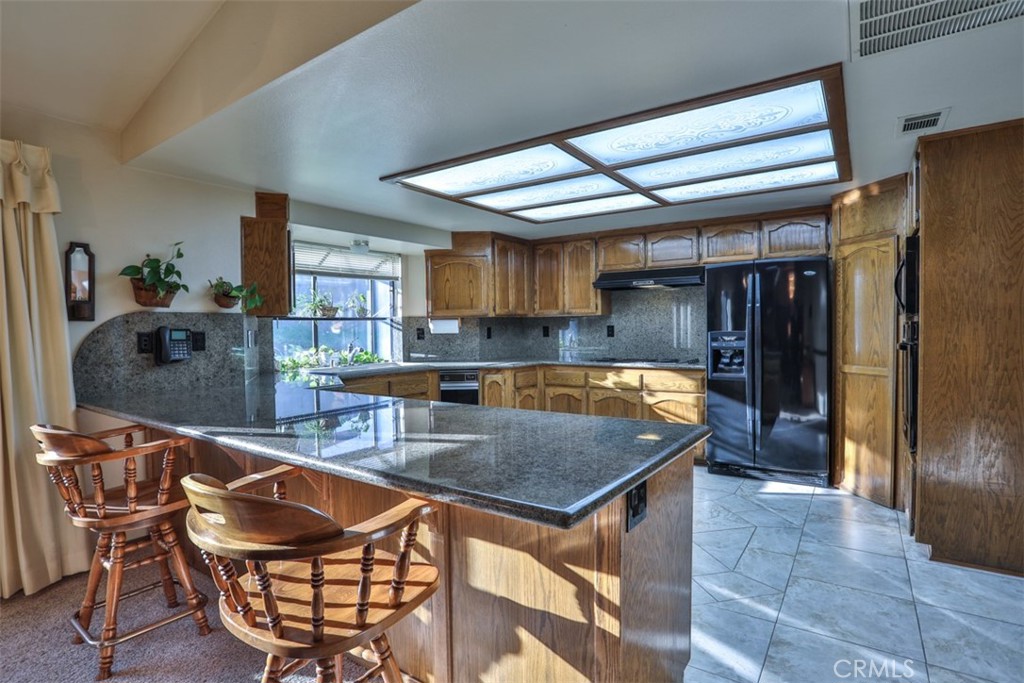 5848 Burlwood Court Rancho Cucamonga, CA 91701 - Photo 40 of 71 a kitchen with stainless steel appliances granite countertop a sink a stove and a refrigerator