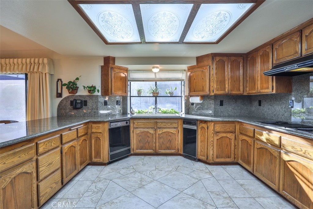 5848 Burlwood Court Rancho Cucamonga, CA 91701 - Photo 41 of 71 a kitchen with stainless steel appliances granite countertop a sink and cabinets
