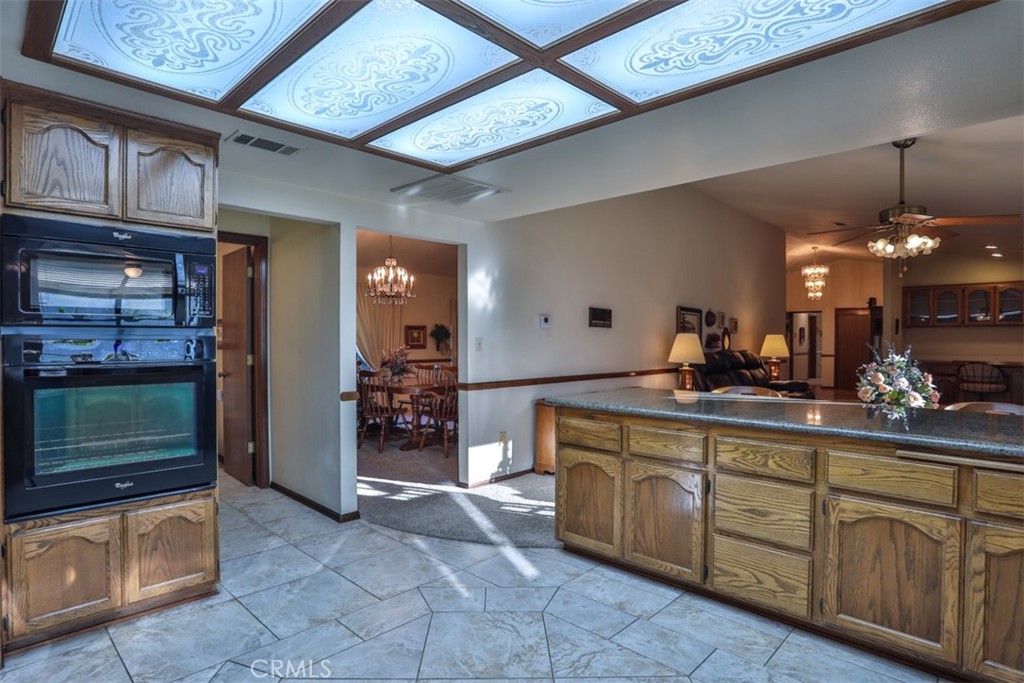 5848 Burlwood Court Rancho Cucamonga, CA 91701 - Photo 44 of 71 a kitchen with cabinets and chandelier
