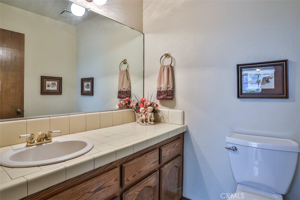 5848 Burlwood Court Rancho Cucamonga, CA 91701 - Photo 46 of 71 a bathroom with a sink and a mirror