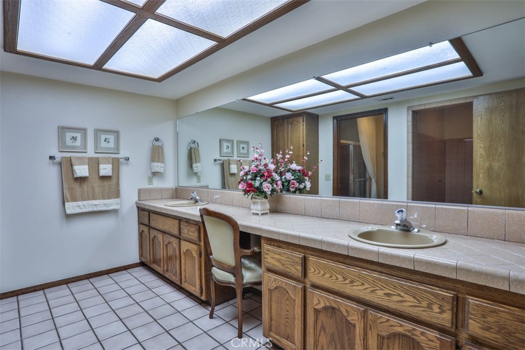 5848 Burlwood Court Rancho Cucamonga, CA 91701 - Photo 52 of 71 a bathroom with a granite countertop sink a mirror and a