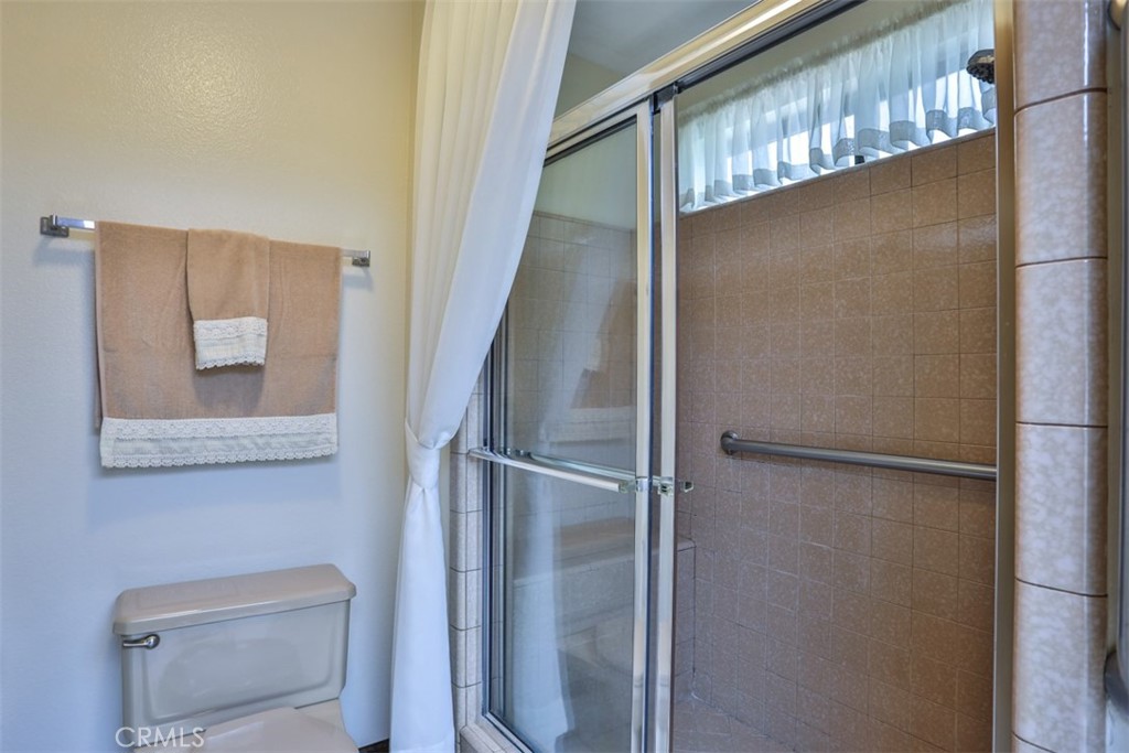 5848 Burlwood Court Rancho Cucamonga, CA 91701 - Photo 54 of 71 a bathroom with a glass shower door