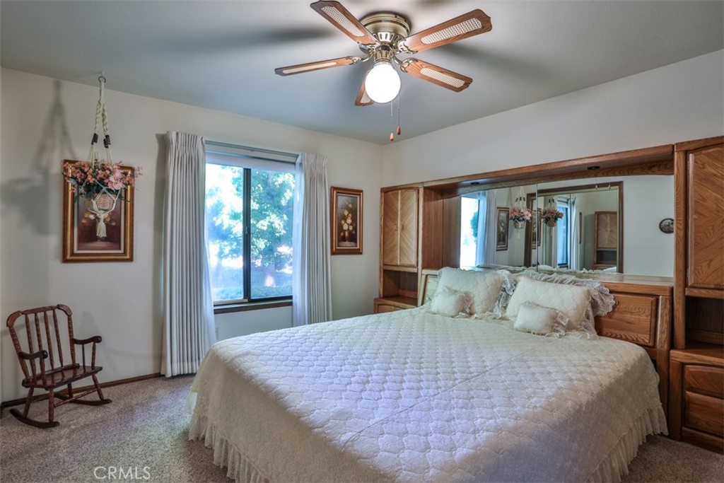 5848 Burlwood Court Rancho Cucamonga, CA 91701 - Photo 58 of 71 a bedroom with a large bed and a chandelier