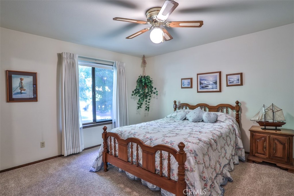 5848 Burlwood Court Rancho Cucamonga, CA 91701 - Photo 60 of 71 a bedroom with a bed and a chandelier