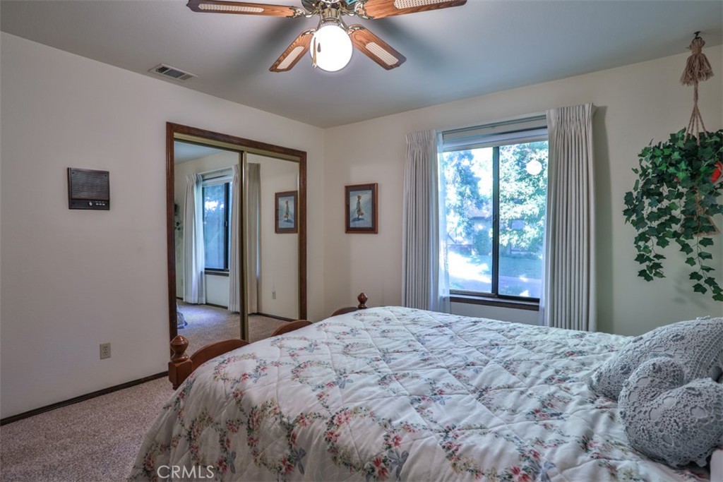 5848 Burlwood Court Rancho Cucamonga, CA 91701 - Photo 61 of 71 a bedroom with a large bed and a chandelier