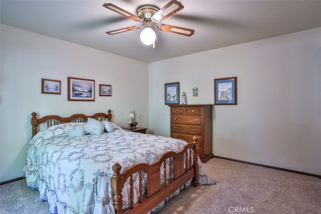 5848 Burlwood Court Rancho Cucamonga, CA 91701 - Photo 62 of 71 a bedroom with a bed and a chandelier
