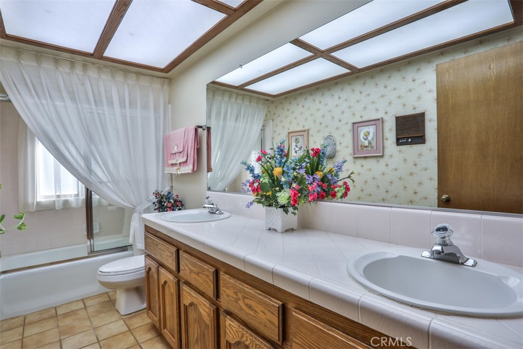 5848 Burlwood Court Rancho Cucamonga, CA 91701 - Photo 63 of 71 a bathroom with a sink a toilet and tub