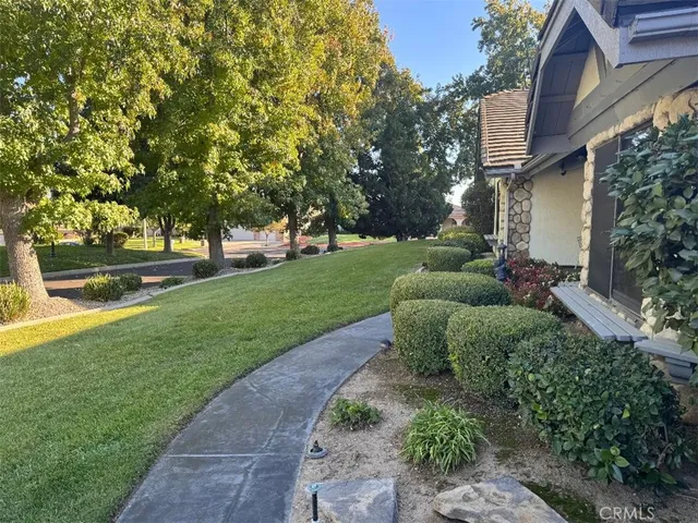 a view of house with backyard and garden