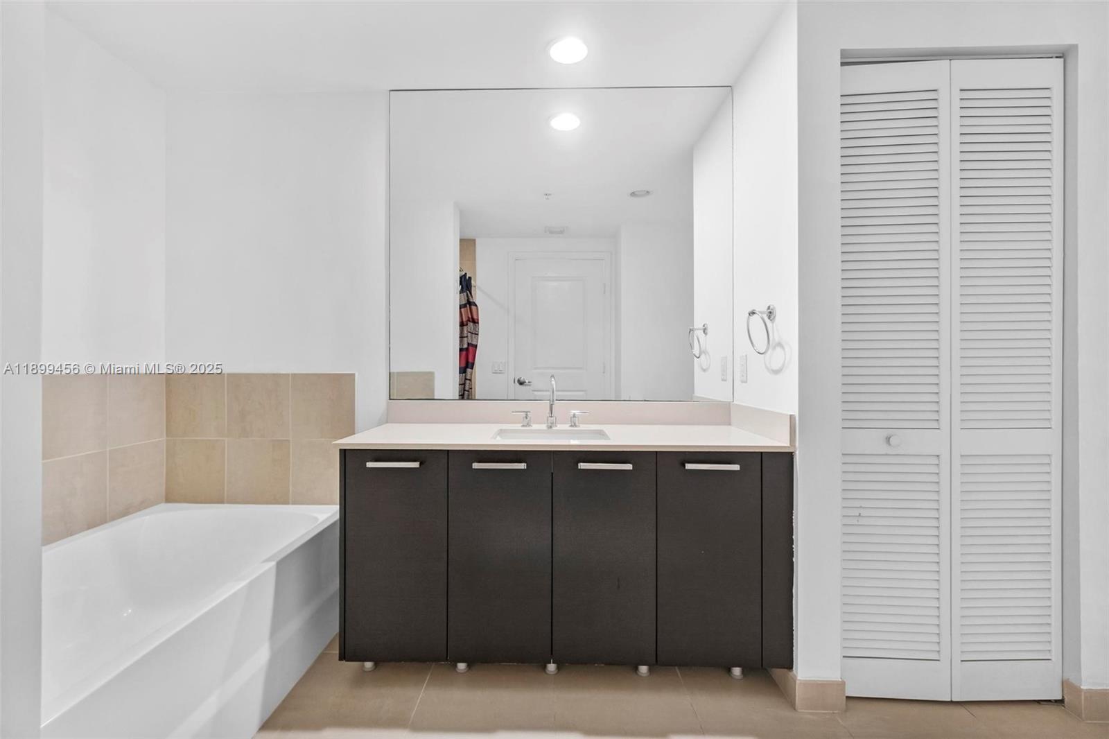 333 Northeast 24th Street, Unit 812 Miami, FL 33137 - Photo 13 of 32 a bathroom with a sink and a mirror