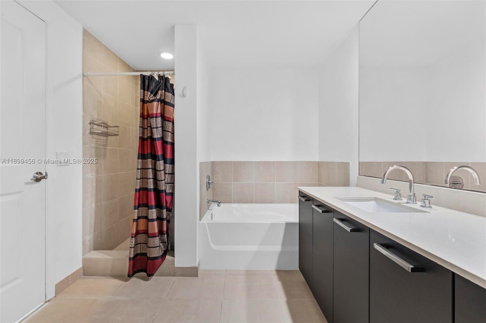 333 Northeast 24th Street, Unit 812 Miami, FL 33137 - Photo 14 of 32 a bathroom with a bathtub and a shower