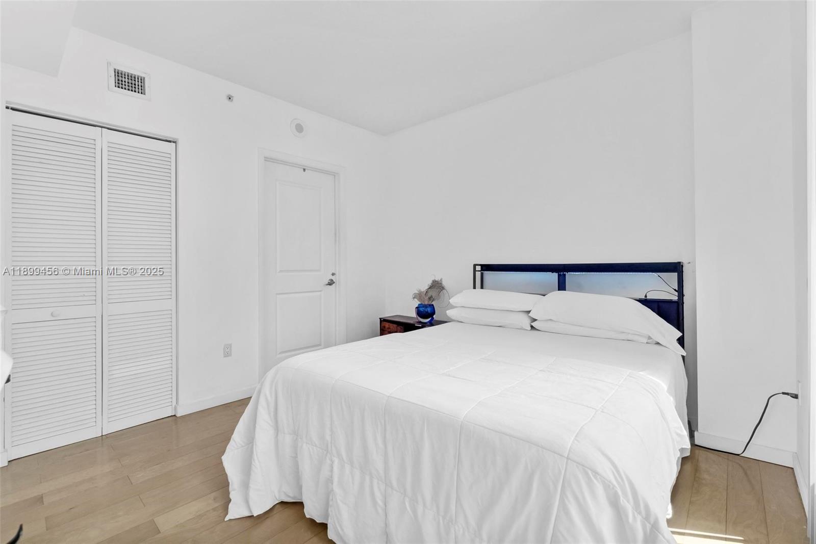 333 Northeast 24th Street, Unit 812 Miami, FL 33137 - Photo 17 of 32 a bedroom with a bed and a chair