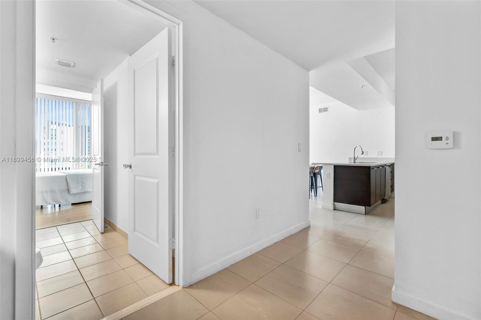 333 Northeast 24th Street, Unit 812 Miami, FL 33137 - Photo 19 of 32 a view of a hallway with a bathroom and a sink