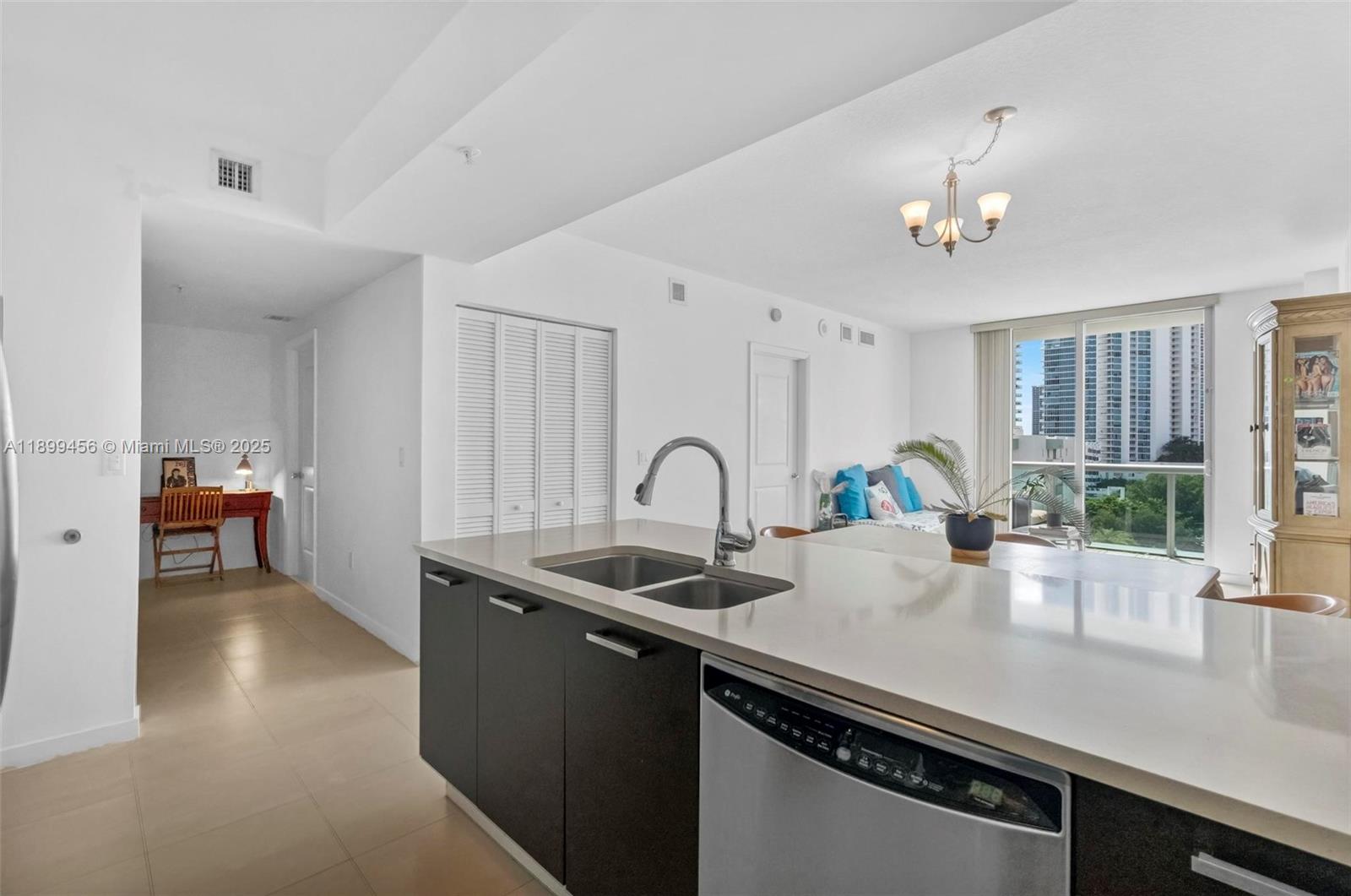 333 Northeast 24th Street, Unit 812 Miami, FL 33137 - Photo 7 of 32 a view of a kitchen with a sink and chandelier