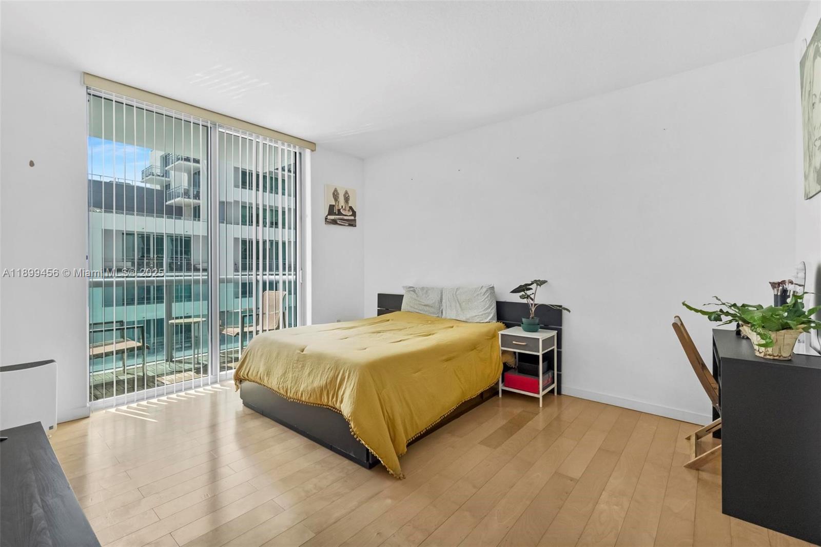 333 Northeast 24th Street, Unit 812 Miami, FL 33137 - Photo 10 of 32 a bedroom with a bed and a potted plant