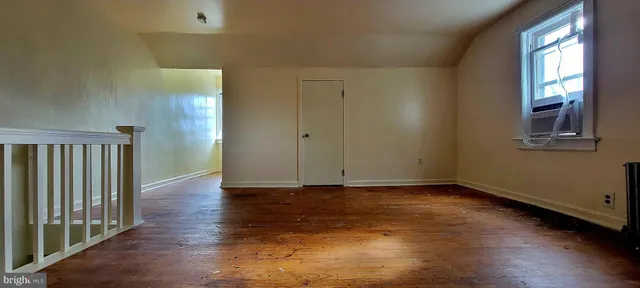 an empty room with closet and entryway