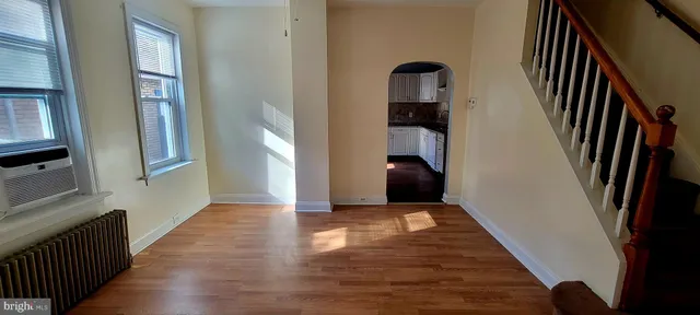 a view of an entryway with wooden floor and stairs