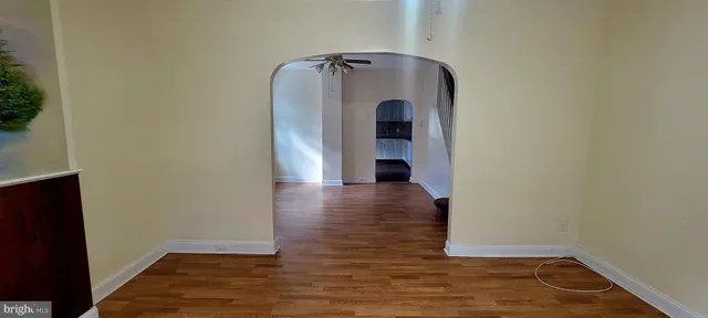 a view of room with window and wooden floor