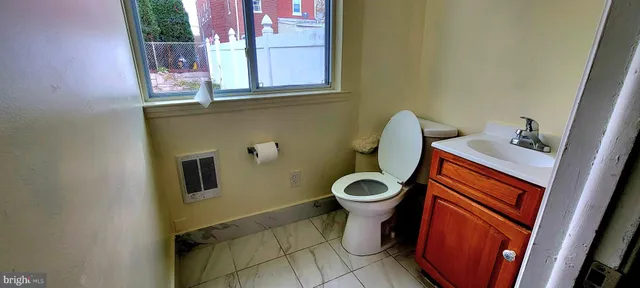 a bathroom with a toilet and a sink