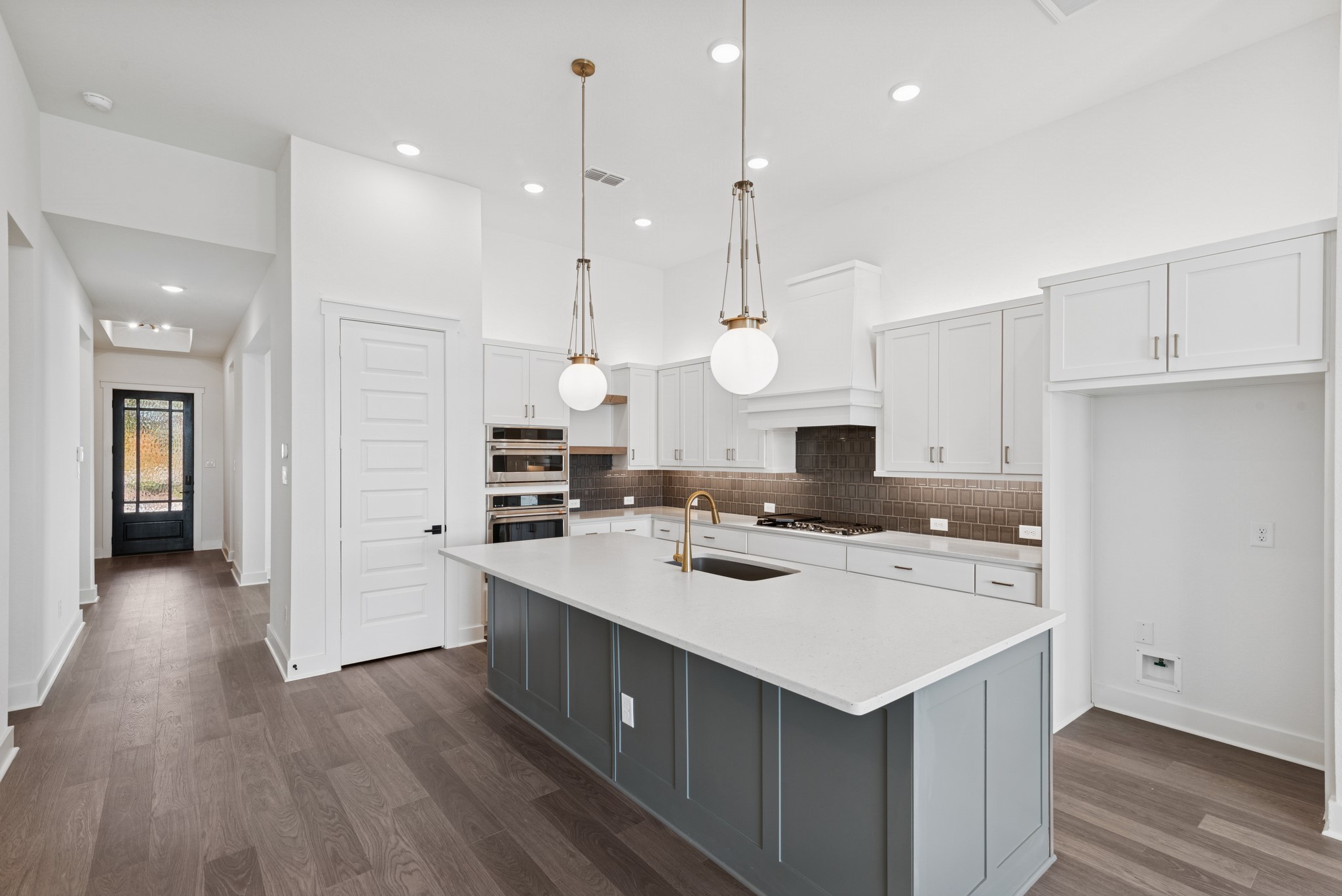 16138 Rita Road Conroe, TX 77302 - Photo 27 of 50 a kitchen that has a lot of cabinets and wooden floor
