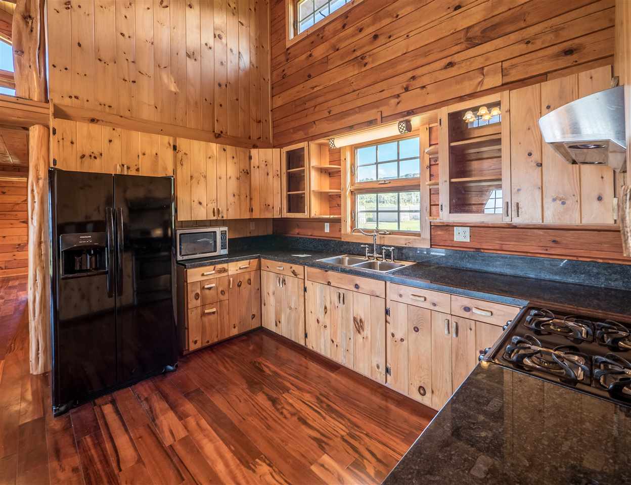 600 Calasa Road Kula, HI 96790 - Photo 12 of 30 a kitchen with granite countertop a stove and cabinets