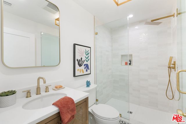 a bathroom with a sink toilet and shower