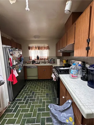 a kitchen with a sink a stove and cabinets