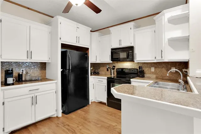 a kitchen with a sink stove and microwave