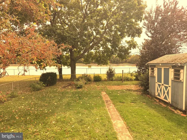 a view of yard with swimming pool and trees