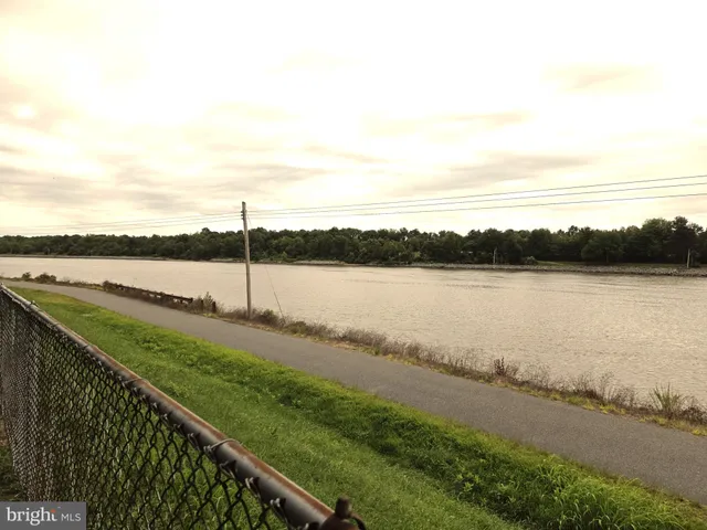 a view of a lake with houses in the back