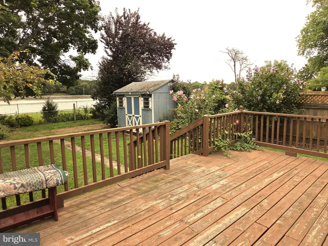 a balcony with wooden floor and fence