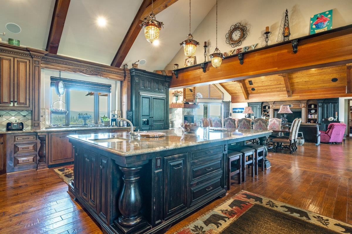 39110 Kearsarge Mill Road Alta, CA 95715 - Photo 39 of 99 a dining hall with stainless steel appliances granite countertop a stove and a large countertops with wooden floor