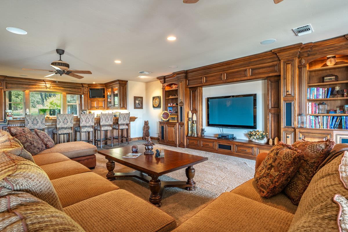 39110 Kearsarge Mill Road Alta, CA 95715 - Photo 50 of 99 a living room with furniture a rug and a flat screen tv