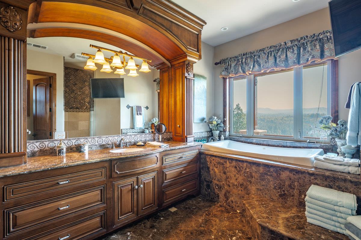39110 Kearsarge Mill Road Alta, CA 95715 - Photo 56 of 99 a bathroom with a sink and a large mirror