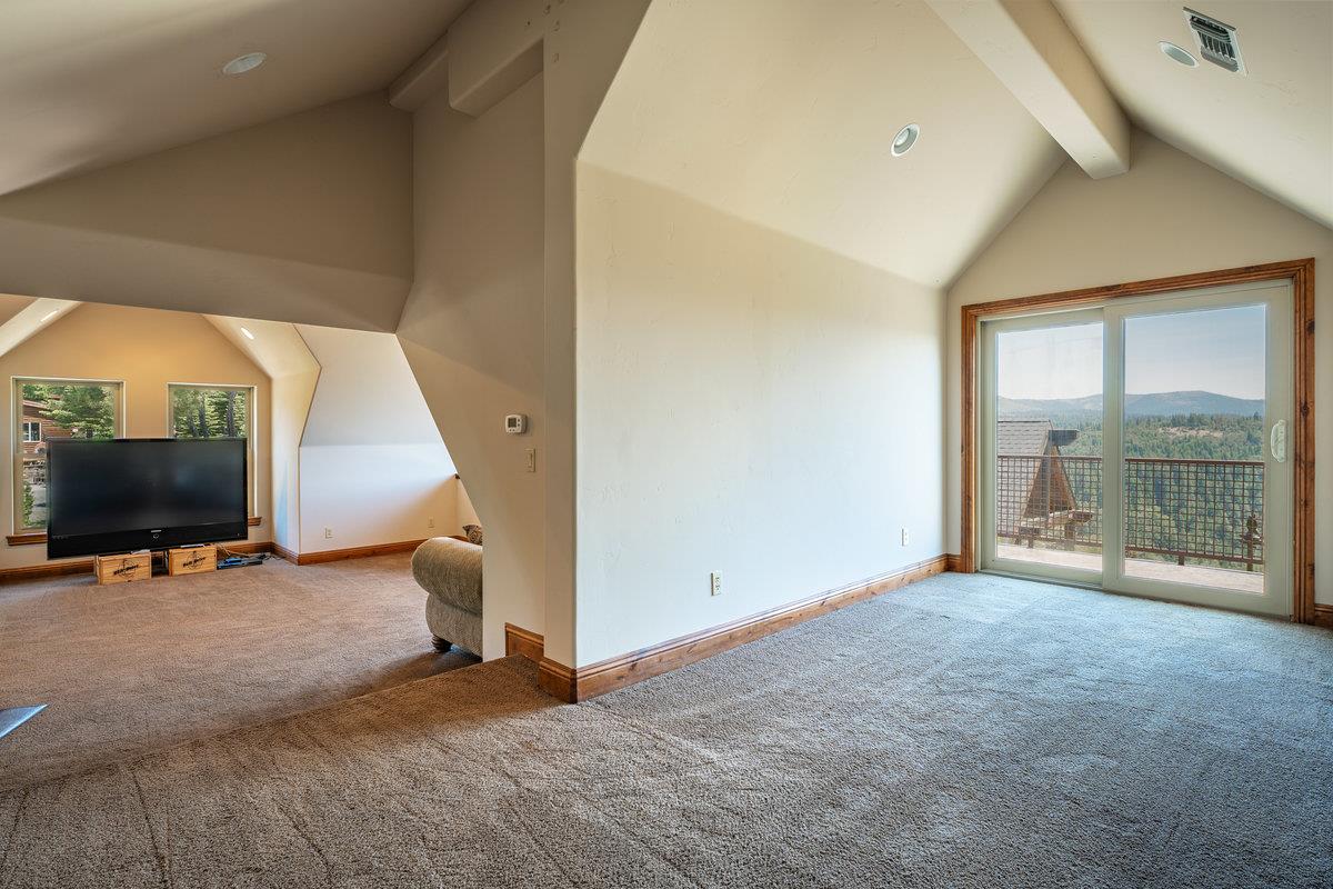 39110 Kearsarge Mill Road Alta, CA 95715 - Photo 66 of 99 a view of an empty room with a fireplace and a flat screen tv