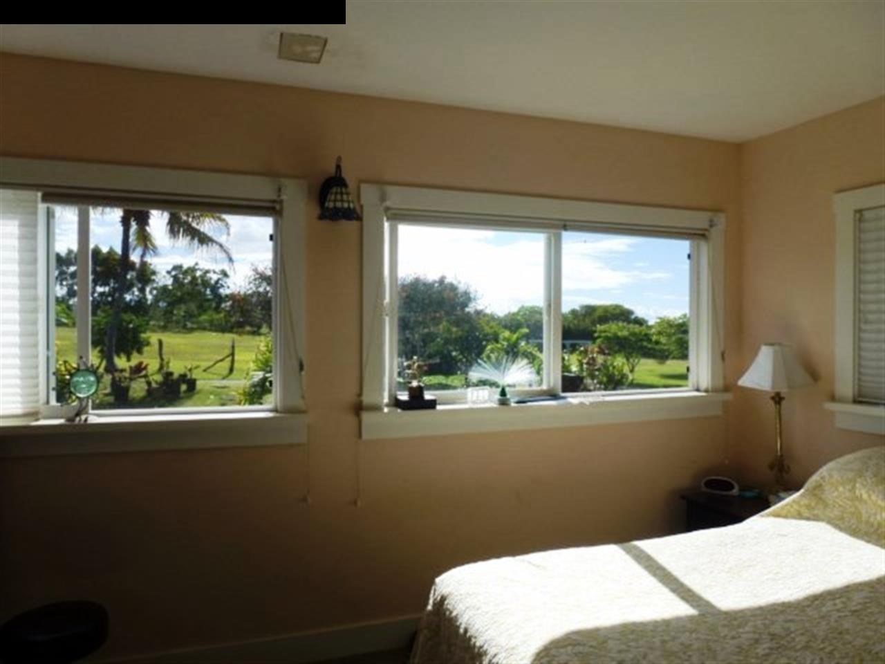 1220 West Kuiaha Road, Unit B1 Haiku, HI 96708 - Photo 12 of 29 a bedroom with a bed and a window