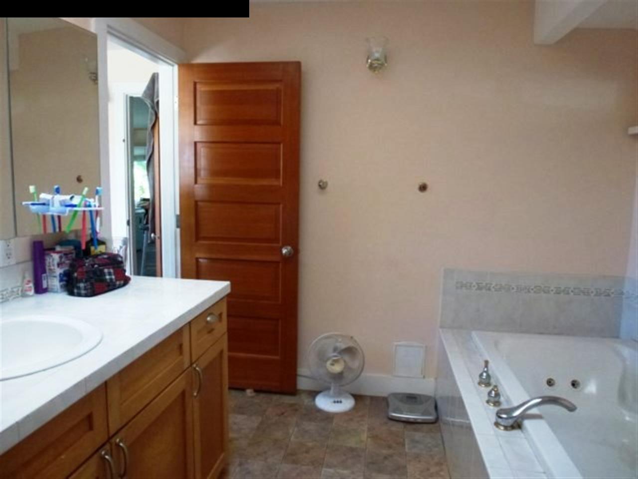 1220 West Kuiaha Road, Unit B1 Haiku, HI 96708 - Photo 15 of 29 a bathroom with a sink toilet and mirror