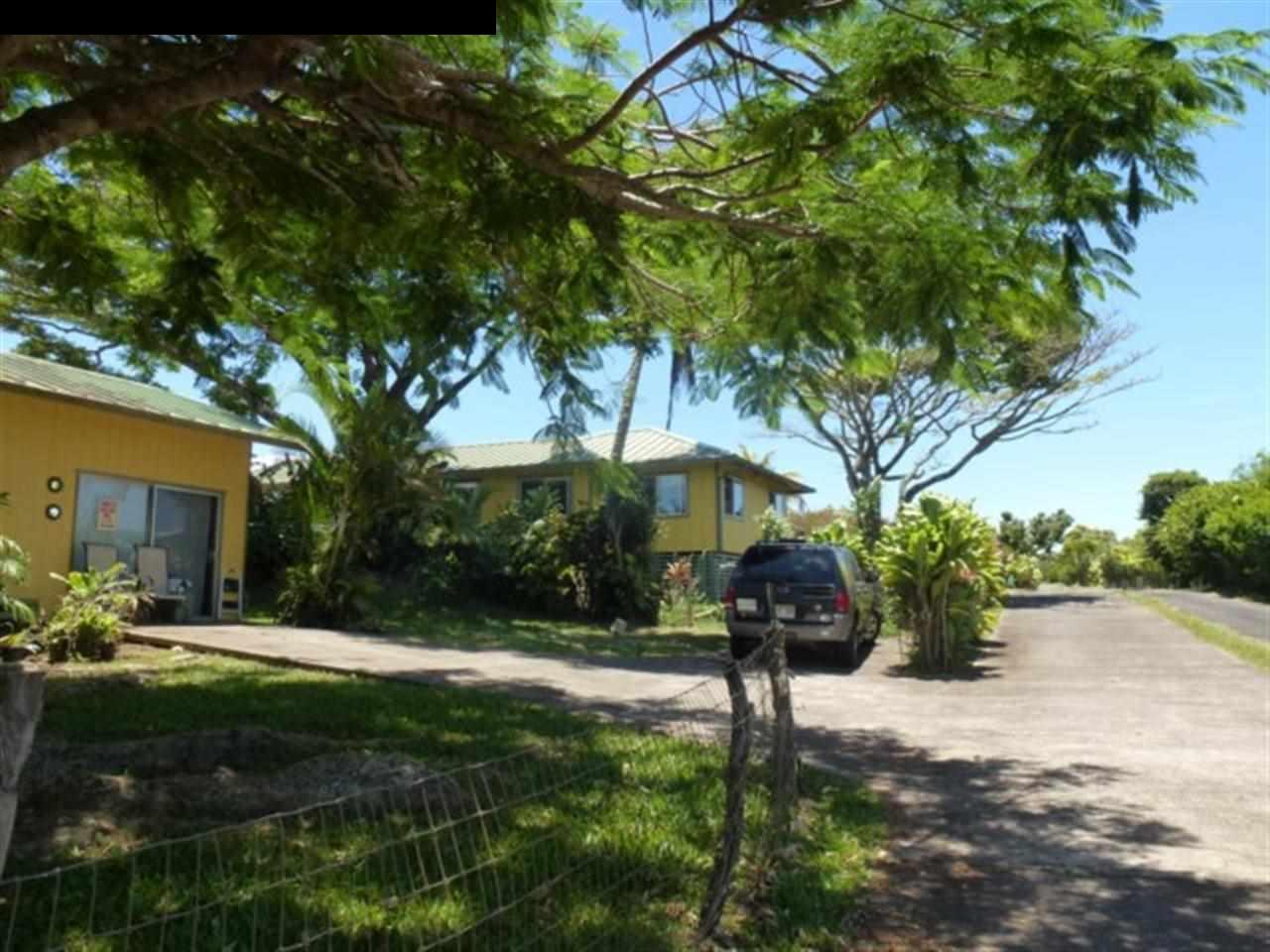 1220 West Kuiaha Road, Unit B1 Haiku, HI 96708 - Photo 22 of 29 a tree in front of a house with a yard