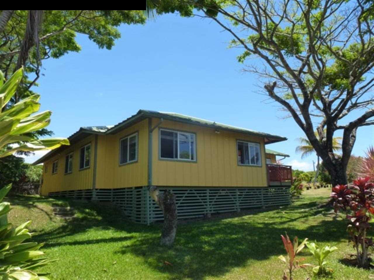 1220 West Kuiaha Road, Unit B1 Haiku, HI 96708 - Photo 7 of 29 a front view of a house with a yard