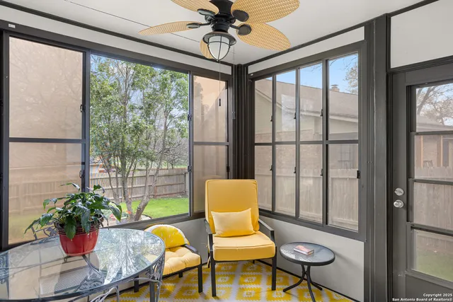 a living room filled with furniture and a potted plant