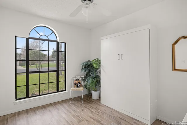 a view of an entryway with wooden floor and a potted plant
