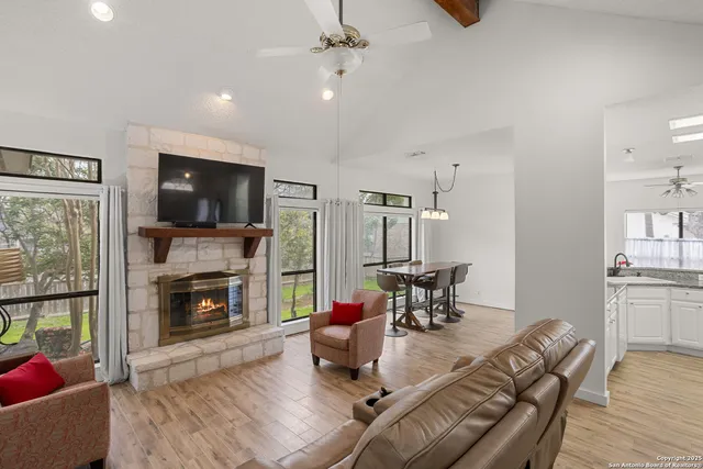 a living room with furniture fireplace and flat screen tv