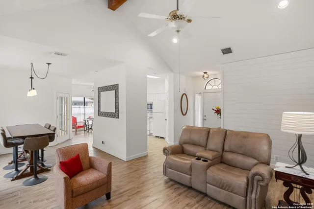 a living room with furniture and a wooden floor