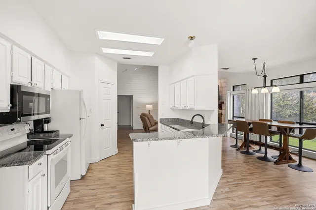 a kitchen with kitchen island granite countertop a sink and counter top space