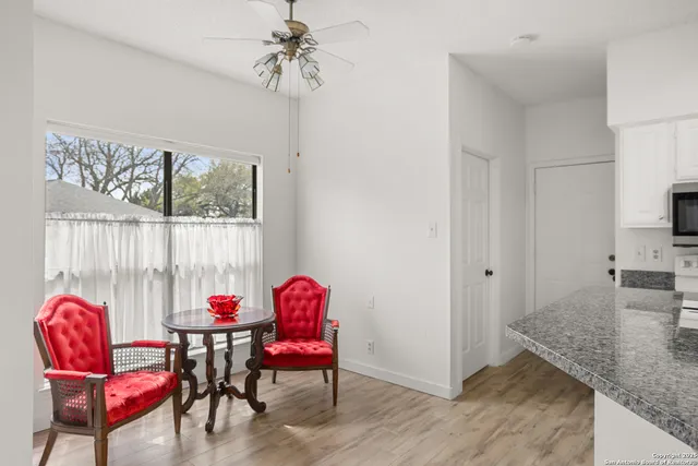 a view of a dining room with furniture and chandelier