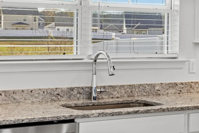 a closeup of a sink and a window